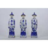 A set of three Chinese blue and white porcelain figures of men, 10½" high