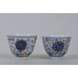 A pair of Chinese doucai porcelain tea bowls with lotus flower decoration, 6 character mark to base,