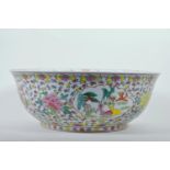 A large Chinese porcelain bowl decorated with deer, mythical beasts and flowers in bright enamels,