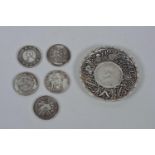 A Chinese white metal coin dish decorated with the emblems of the Eight Immortals, together with