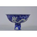 A Chinese blue and white porcelain stem bowl decorated with a dragon chasing the flaming pearl, 6