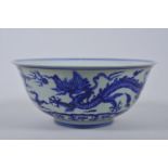 A Chinese blue and white porcelain bowl decorated with dragons, 6 character mark to base, 8½"