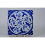 A Chinese blue and white porcelain tile decorated with cranes in flight, 8" x 8"