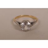 An 18ct gold and platinum set ring set with a large solitaire white sapphire, size 'Q', gross 3.4