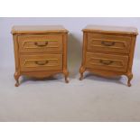 A pair of French style oak bedside chests, with shaped tops, two drawers, raised on cabriole