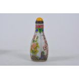 A Chinese enamelled glass snuff bottle with floral decoration, 4 character mark to base, 3½" high