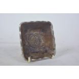 A Chinese white metal square form trinket dish with auspicious symbol and bat decoration,