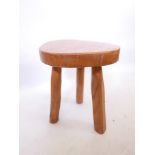 A traditional elm milking stool, 16" high x 14" wide