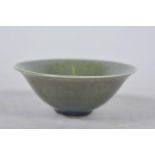 A Chinese olive green glazed shallow bowl, A/F, minuscule chip to rim, 3½" diameter