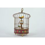 A Chinese brass bird cage automaton clock with a cloisonne band to the base, 8" high