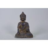 A Chinese bronze of Buddha with a gilt patina, 7" high