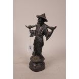 A Chinese bronze figure of a man bearing a yoke, 10" high