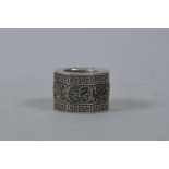 A Chinese white metal archer's thumb ring of octagonal form with reticulated panel depicting