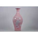 A Chinese pink ground porcelain vase with raised decoration of birds and butterflies amongst