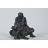 An Imperial Russian cast iron box in the form of Lohan seated on a frog, bearing the Kasli foundry