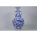 A Chinese Ming style, blue and white pottery vase with two handles and carp decoration, 13½" high