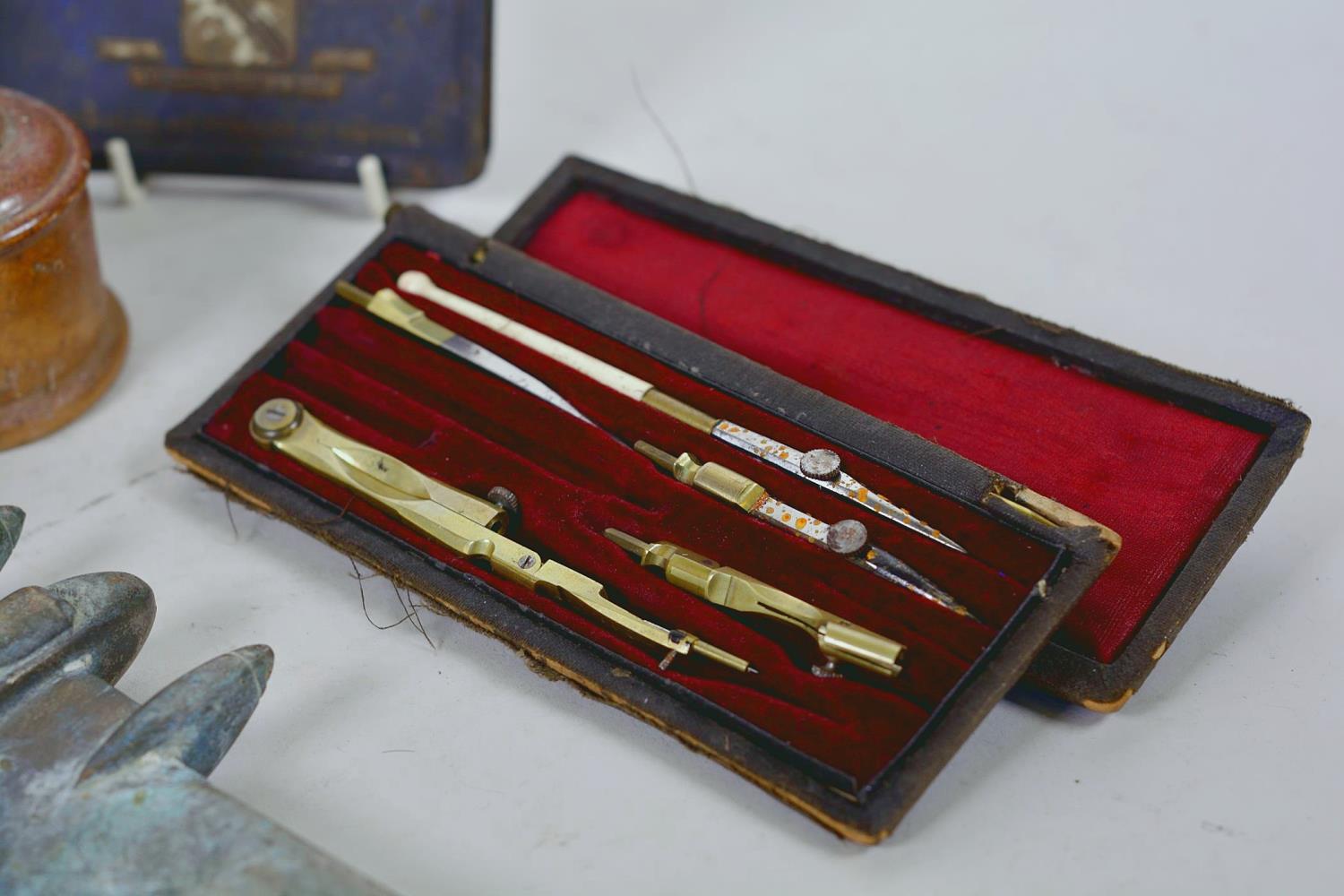 A box of collectables including a brass model Mosquito aircraft, Royalty cigarette tin, drawing set, - Image 10 of 11