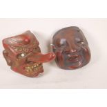 A Japanese lacquered plaster Tengu mask and another similar, 8", one A/F