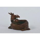 A Chinese bronzed metal coiled dragon, impressed mark to base, 2" high x 2" diameter