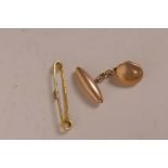 A single gold cufflink marked 10ct and a 9ct gold bar brooch (3.7 grams)