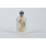 A Chinese reverse decorated glass snuff bottle depicting birds amongst flowers, 3" high