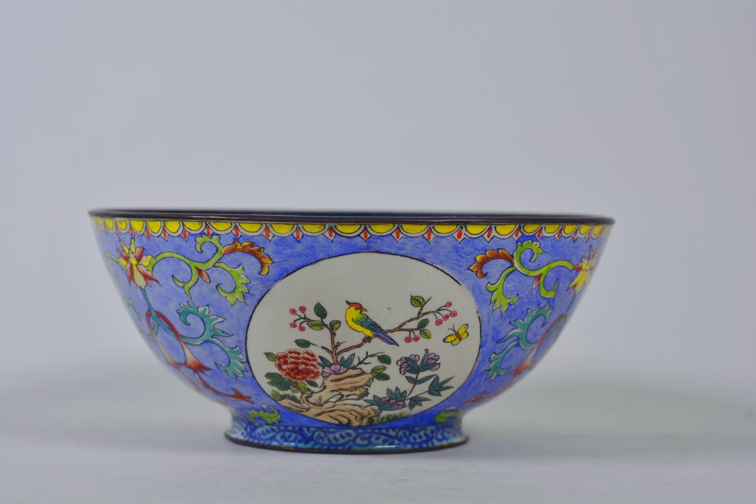 A Chinese Canton enamelled copper bowl with decorative panels depicting birds amongst flowers, 4