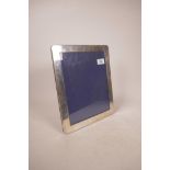 A hallmarked silver photo frame, aperture 8" x 10"