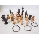 A varied collection of twenty three hand carved African hardwood and soft wood figures, bangles