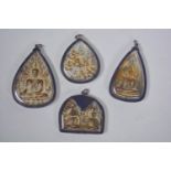 Four South East Asian Buddhist icon pendants, largest 3"