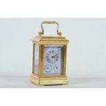 A brass cased miniature carriage clock with Sevres style porcelain panels and two subsidiary date