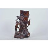 A Chinese carved hardwood brush pot in the form of birds perched on bamboo, 9" high