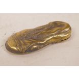 A novelty brass vesta case in the form of a lady's shoe within a shoe, 3" long