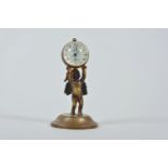 A brass ball desk clock on a cherub stand, 4" high