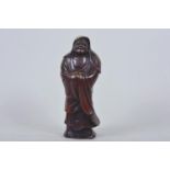 An oriental stoneware figurine of Lohan with bronzed glaze, 7½" high