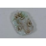 A Chinese carved and pierced jade pendant in the form of a lotus flower, 3" x 2"
