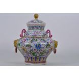 A Chinese polychrome porcelain jar and cover with loose ring handles and all over lotus flower
