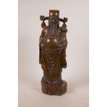 A Chinese carved hardwood figure of an Immortal, 15½" high