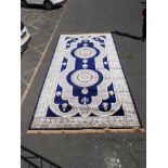 A large Turkish blue ground carpet with all over floral decoration, 118" x 240"