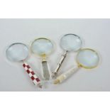 Four desk top magnifying glasses, various designs