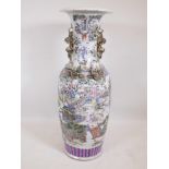 A Chinese famille verte pottery floor vase with two fo dog handles, decorated with figures in a