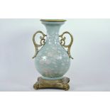 A Chinese celadon glazed porcelain vase with ormolu style mount and raised floral decoration, seal