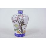 A Chinese porcelain vase with bulbous shoulder and narrow neck decorated with birds on a flowering