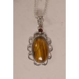 A silver pendant necklace set with tiger's eye, pendant 2" drop