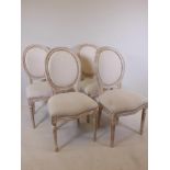 A set of four painted French style dining chairs