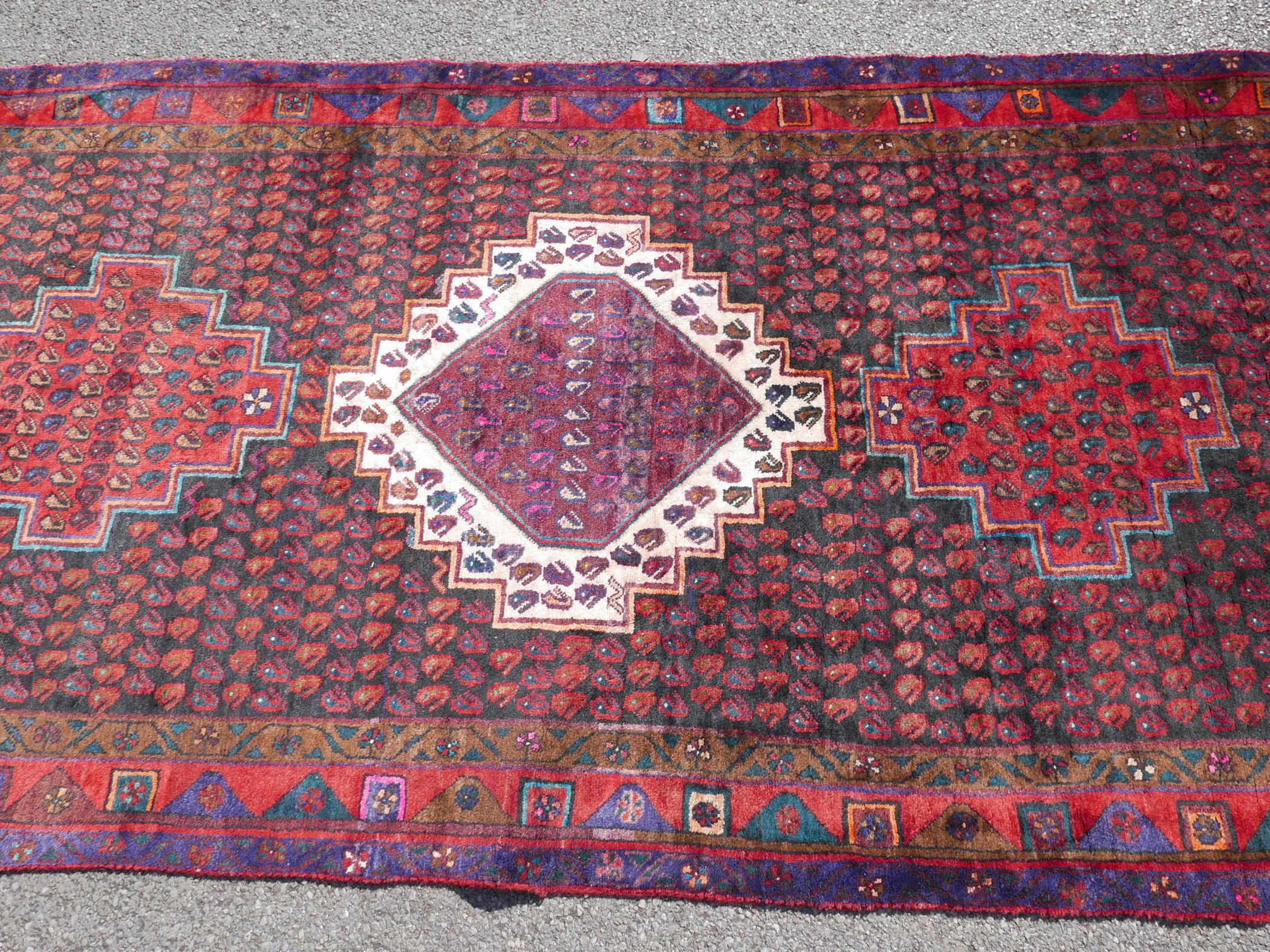 A Persian red ground Hamadan luri rug, 61" x 18" - Image 2 of 4