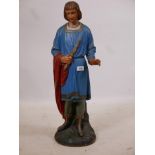 A carved and painted wood figure of a young man in medieval garb bearing a sceptre, late C19th/early