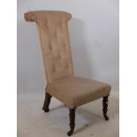 An early C19th prie dieu chair, raised on carved rosewood supports with brass castors