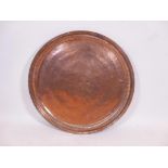 An Islamic copper tray with engraved decoration, 27½" diameter