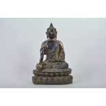 A Chinese patinated bronze figure of Buddha seated in meditation, 12" high