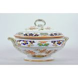 An 1873 Minton stately porcelain oval tureen in the Imari style, with a matching domed cover with